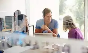 A group of people talking in an office