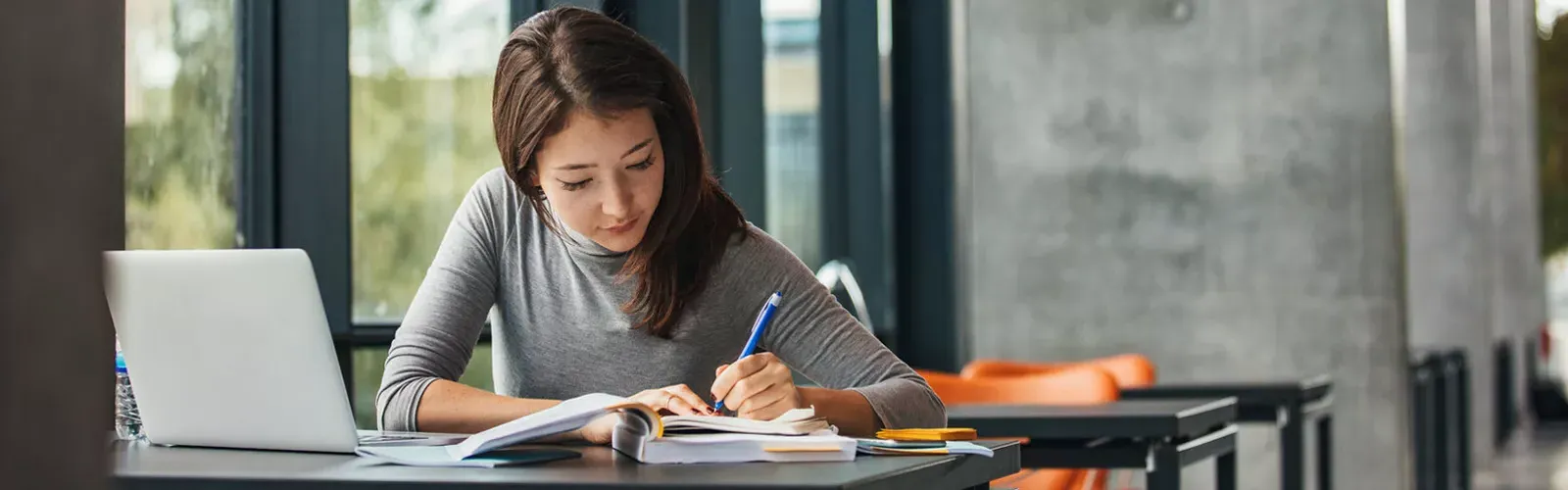 Woman doing homework at a table.