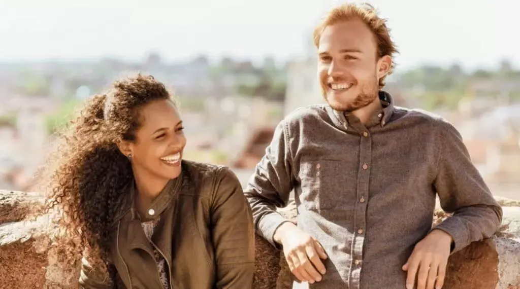 A man and a woman laughing and smiling