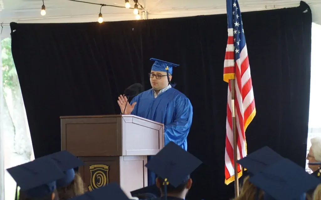 Graduate Nicolas Pinero Mortarboards speaking at graduation