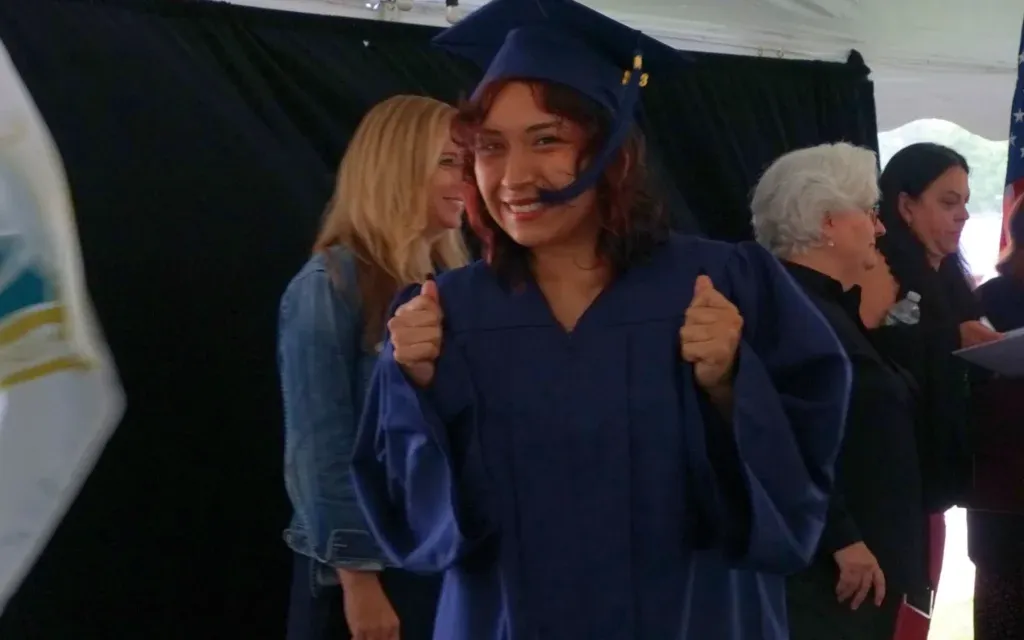 Graduate giving a thumbs up